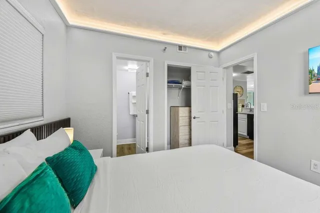 a bedroom with a bed and a window