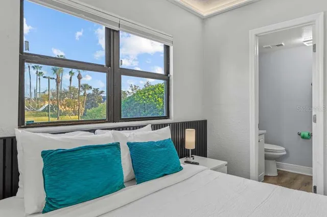 a en suite bathroom with a granite countertop sink and a mirror
