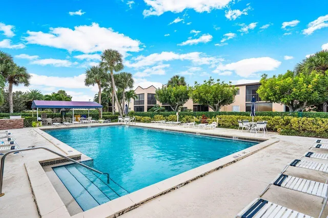 a view of swimming pool with outdoor seating and plants