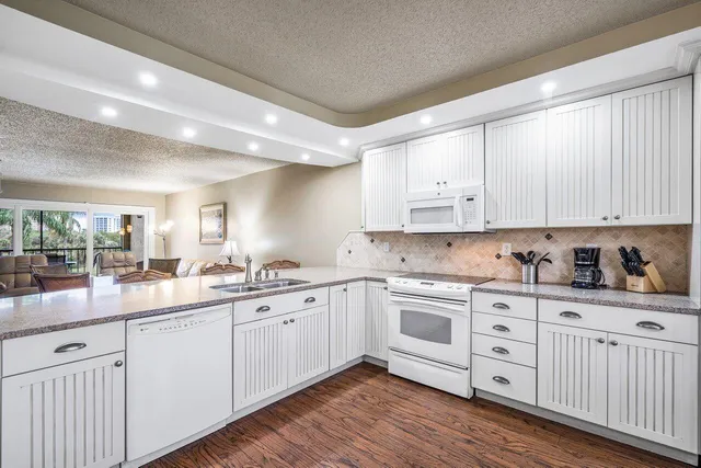 a kitchen with sink cabinets and wooden floor