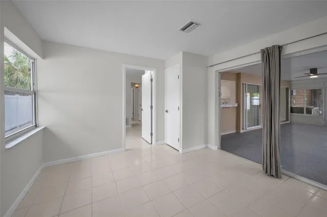 a backyard of a house with barbeque oven table and chairs