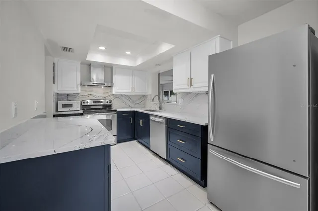 a kitchen with a stove sink and cabinets