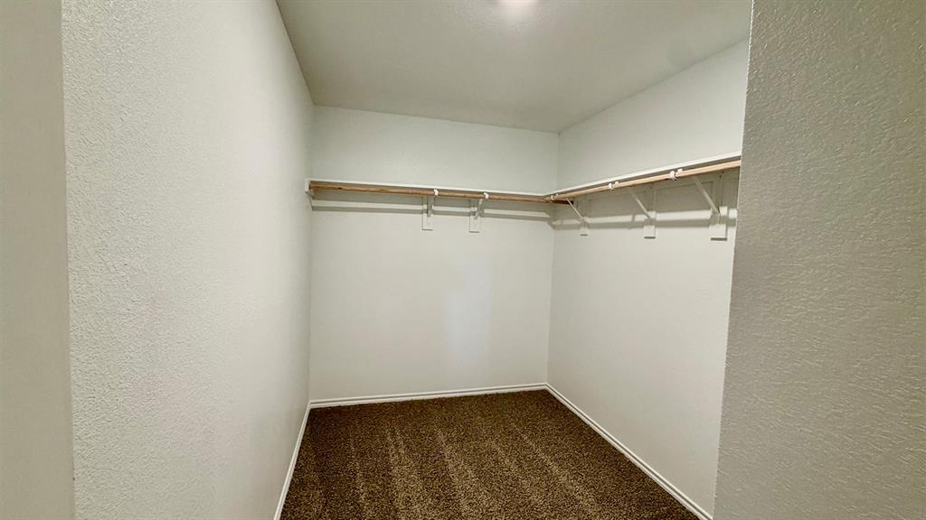 2003 Reveille Way Terrell, TX 75160 - Photo 5 of 25 Walk-in closet featuring plush brown carpeting and white walls