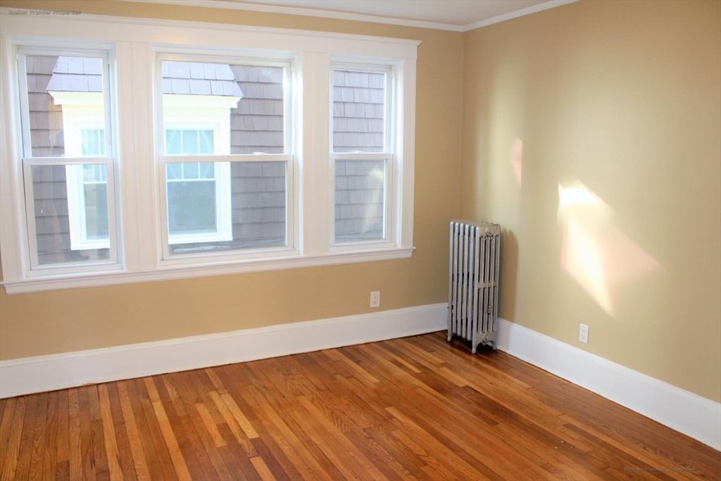 14 Ginita Street, Unit 1 Boston, MA 02122 - Photo 2 of 12 a view of empty room with wooden floor and fan