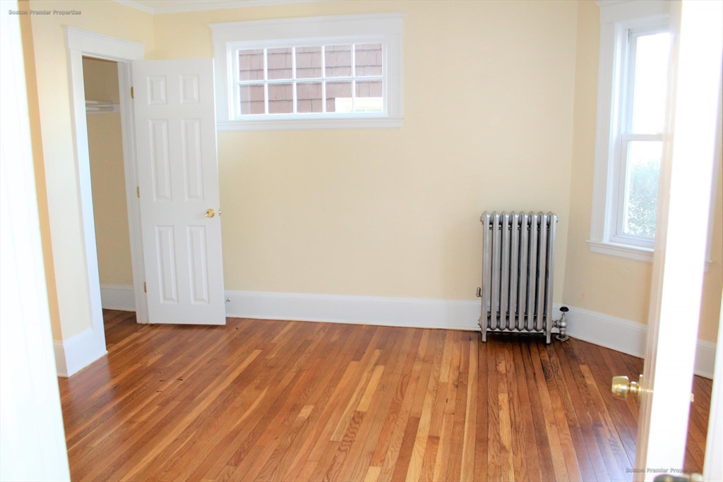 14 Ginita Street, Unit 1 Boston, MA 02122 - Photo 4 of 12 an empty room with wooden floor and windows