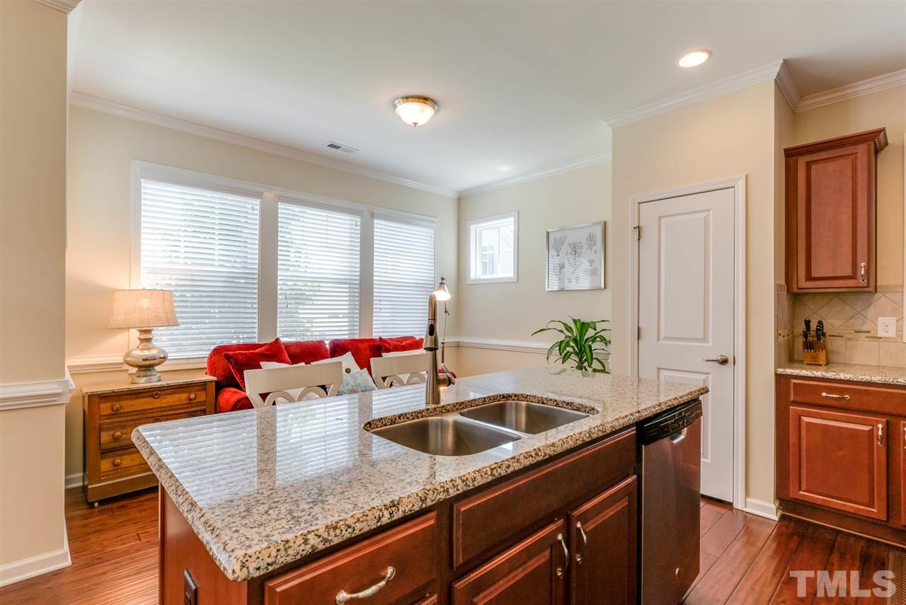 1564 Rodessa Run Raleigh, NC 27607 - Photo 11 of 25 a kitchen with stainless steel appliances granite countertop a sink a stove and a wooden floors