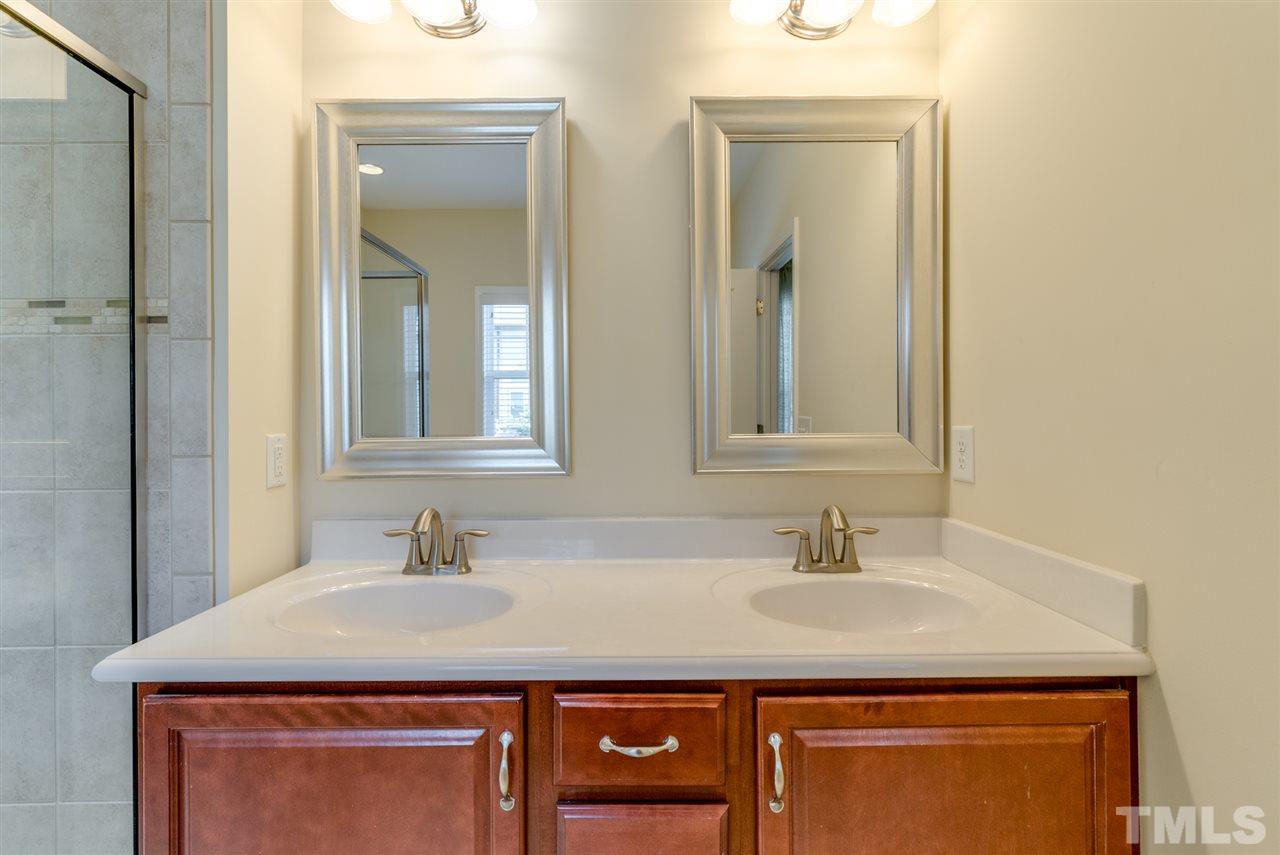 1564 Rodessa Run Raleigh, NC 27607 - Photo 17 of 25 a bathroom with a sink and a mirror