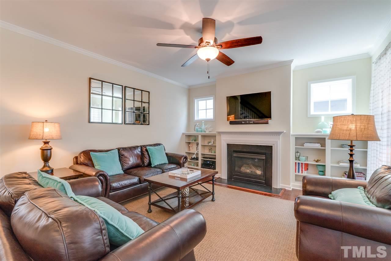 1564 Rodessa Run Raleigh, NC 27607 - Photo 3 of 25 a living room with furniture a fireplace and a flat screen tv
