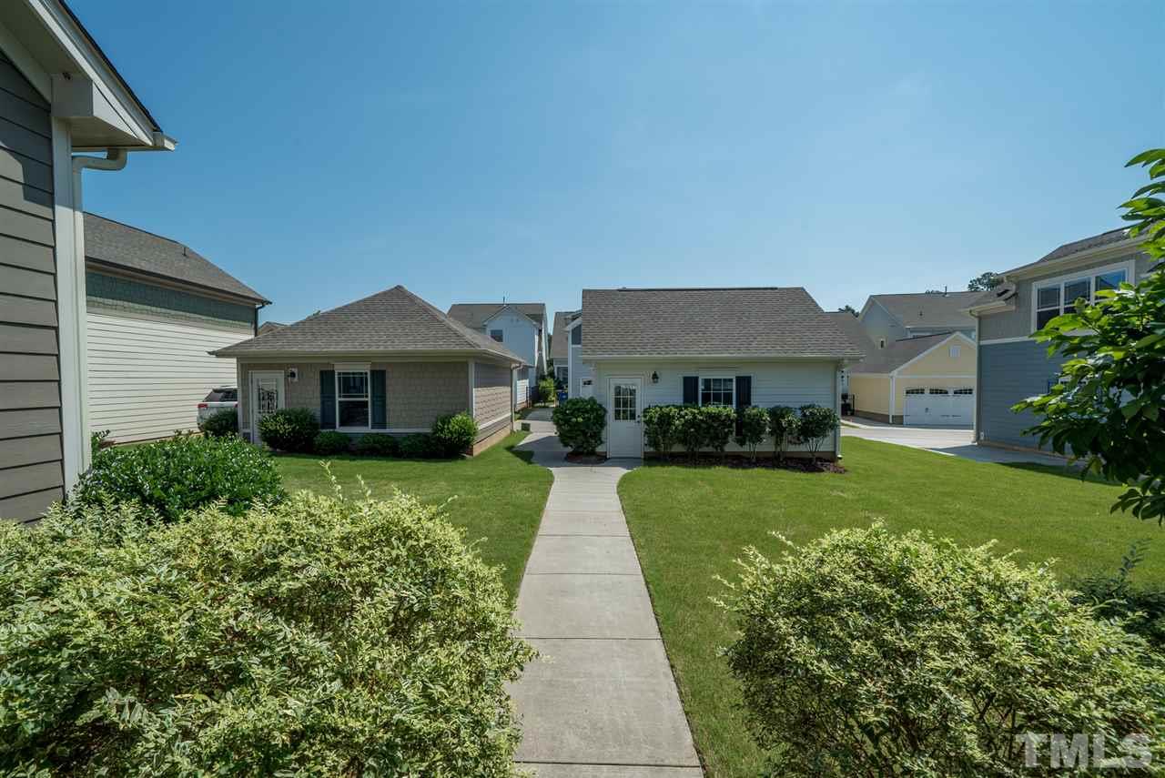 1564 Rodessa Run Raleigh, NC 27607 - Photo 23 of 25 a front view of a house with a yard and potted plants