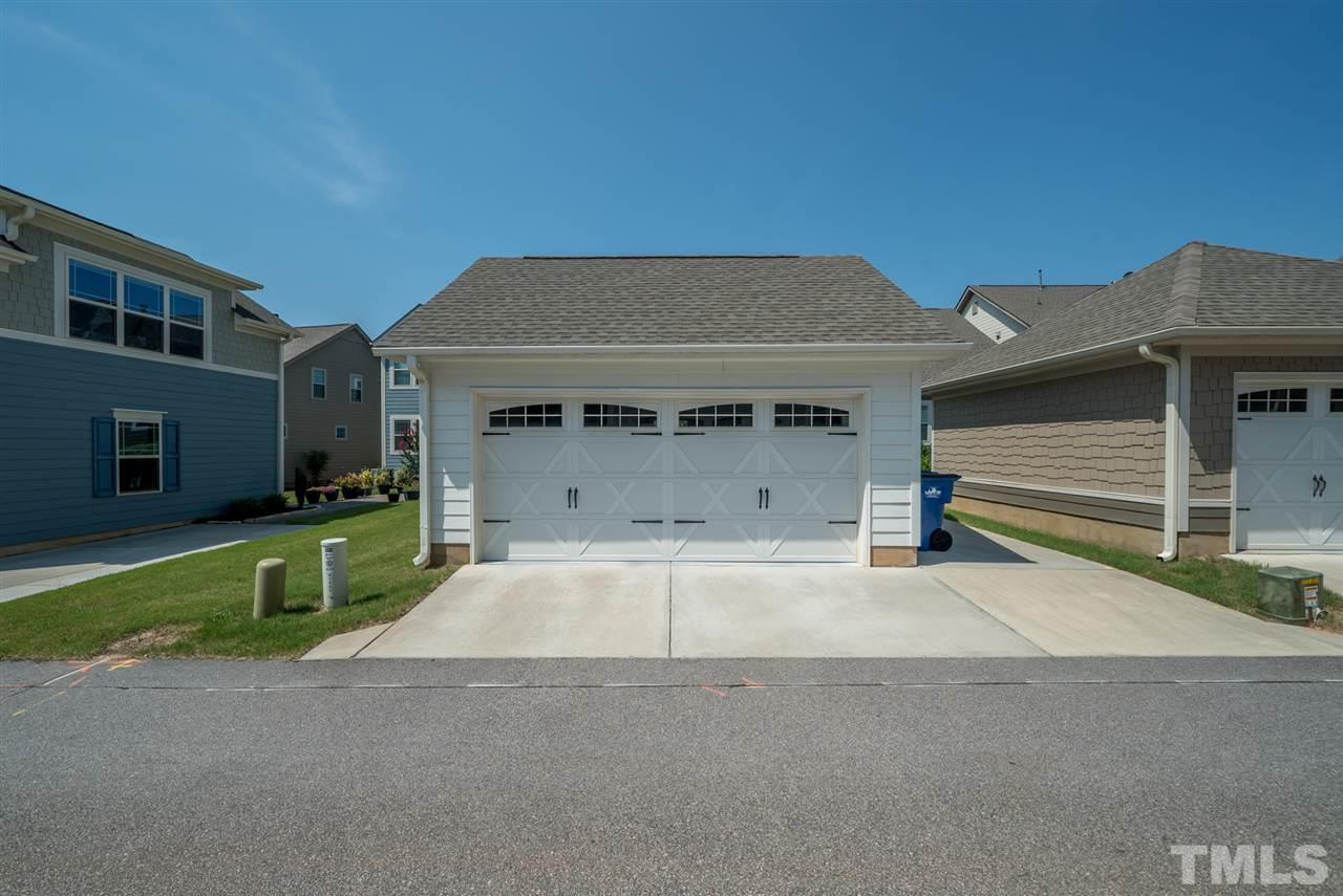 1564 Rodessa Run Raleigh, NC 27607 - Photo 24 of 25 a front view of a house with a yard and garage