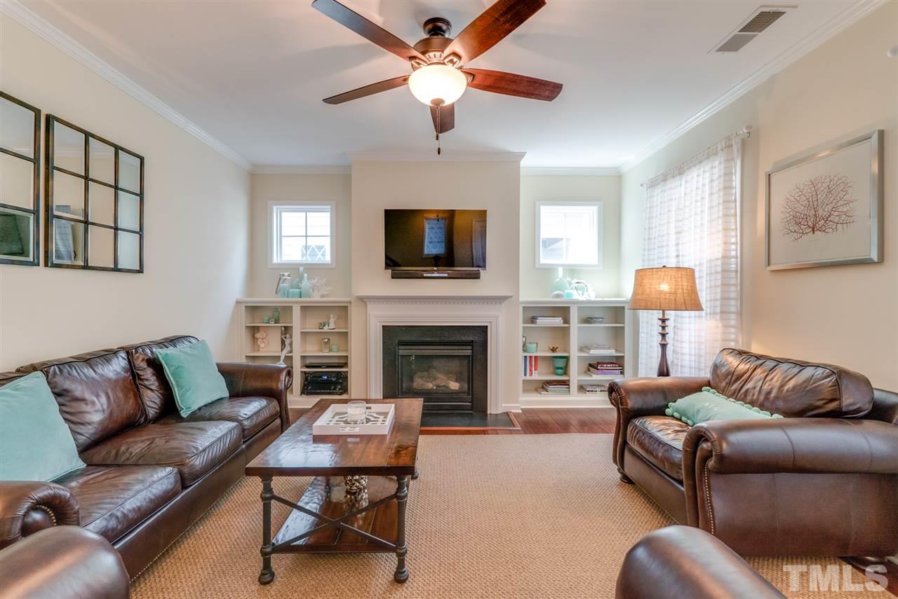1564 Rodessa Run Raleigh, NC 27607 - Photo 4 of 25 a living room with furniture a fireplace and a flat screen tv