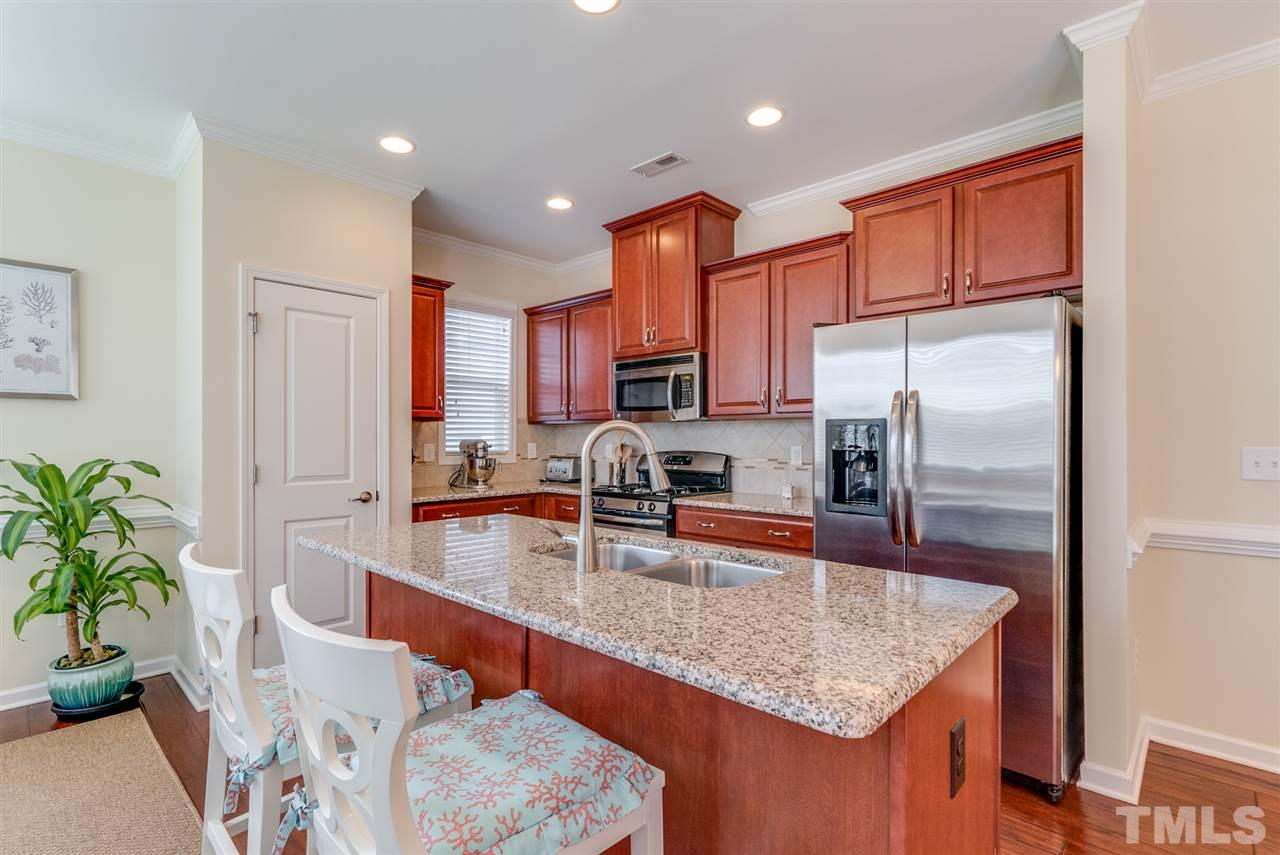 1564 Rodessa Run Raleigh, NC 27607 - Photo 6 of 25 a kitchen with granite countertop a sink a counter top space stainless steel appliances and cabinets