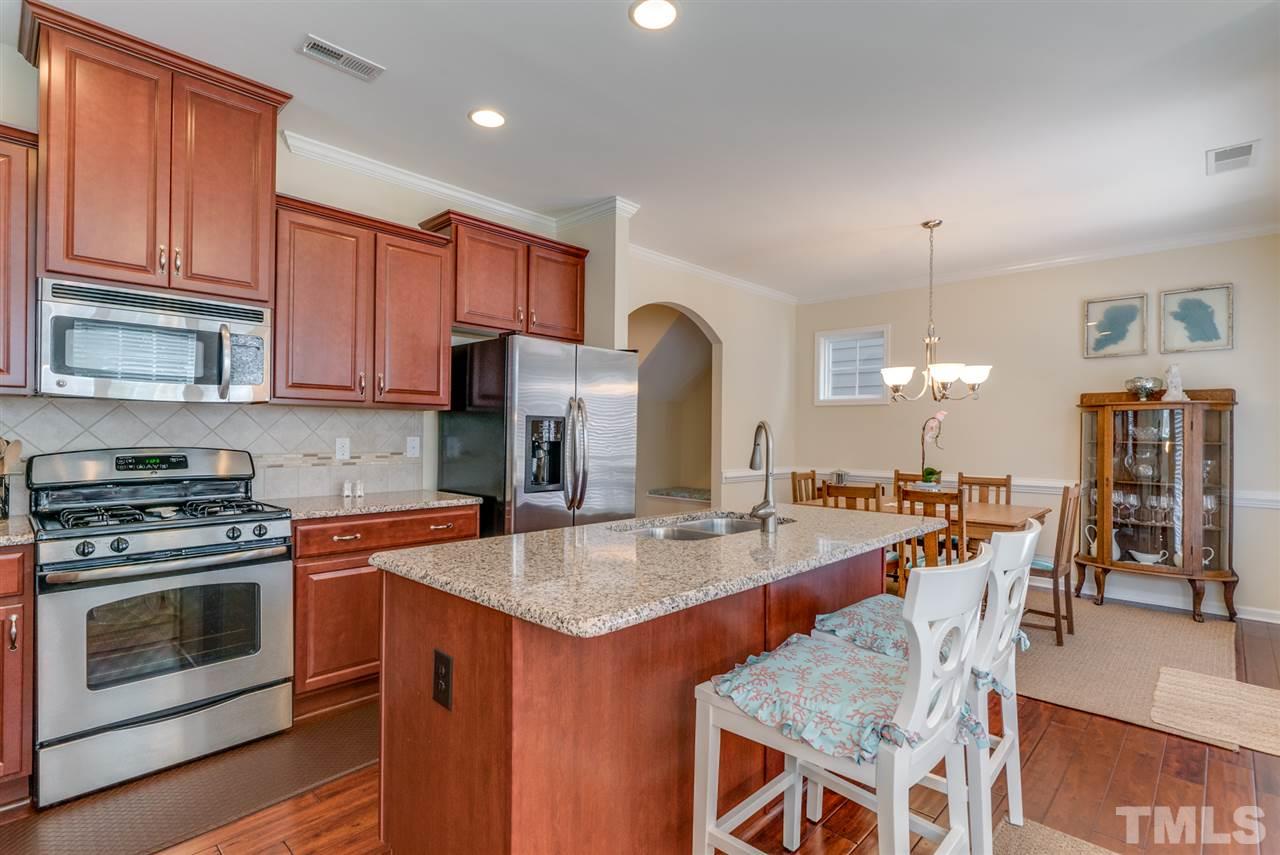 1564 Rodessa Run Raleigh, NC 27607 - Photo 9 of 25 a open kitchen with stainless steel appliances granite countertop a stove top oven a sink counter space and cabinets