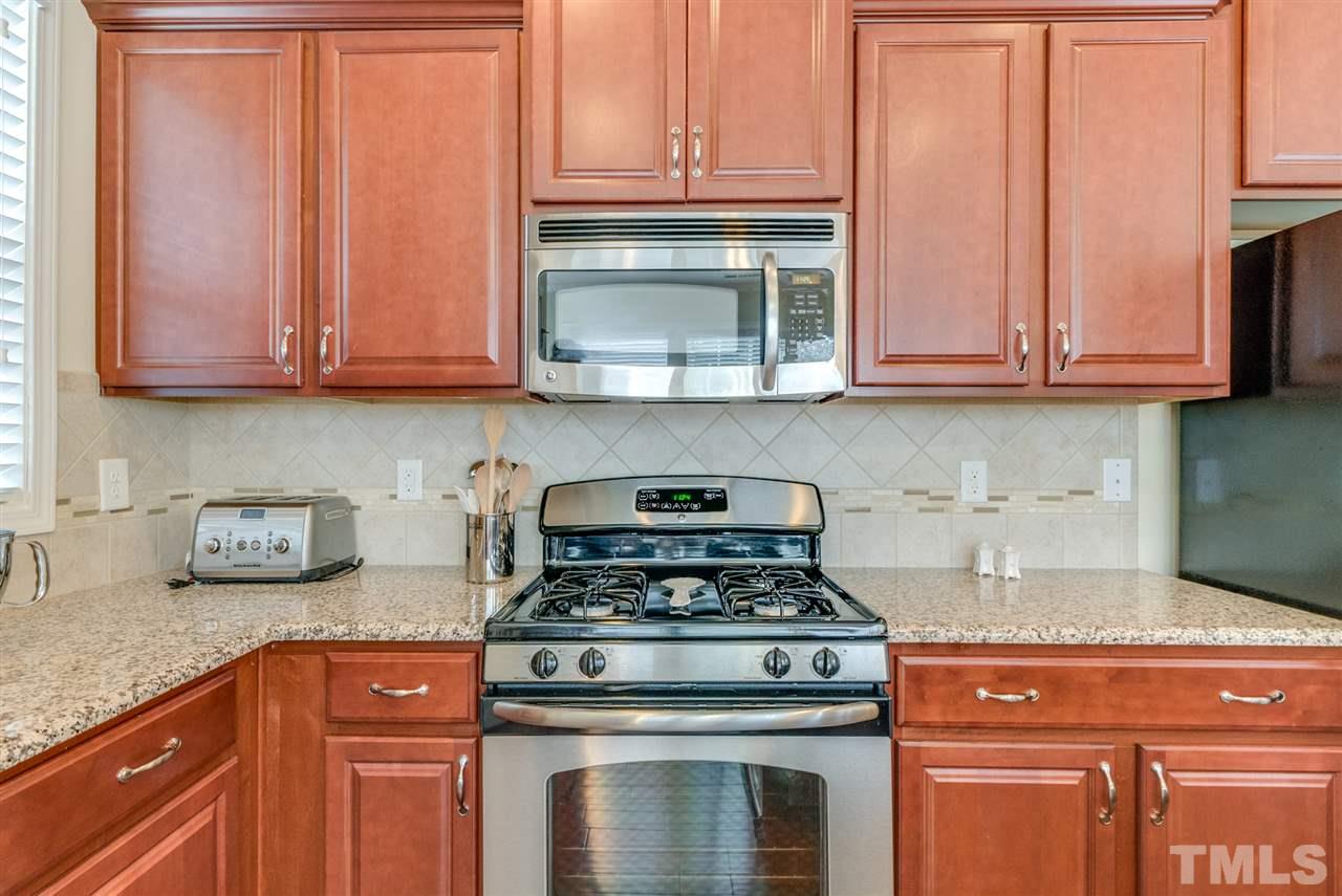 1564 Rodessa Run Raleigh, NC 27607 - Photo 10 of 25 a kitchen with granite countertop cabinets and stainless steel appliances
