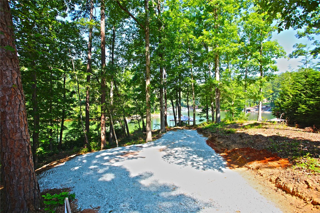 1359 Hbr Rdg Road Seneca, SC 29672 - Photo 36 of 39 A tranquil lakefront lot offers direct water access amidst a lush, wooded setting.