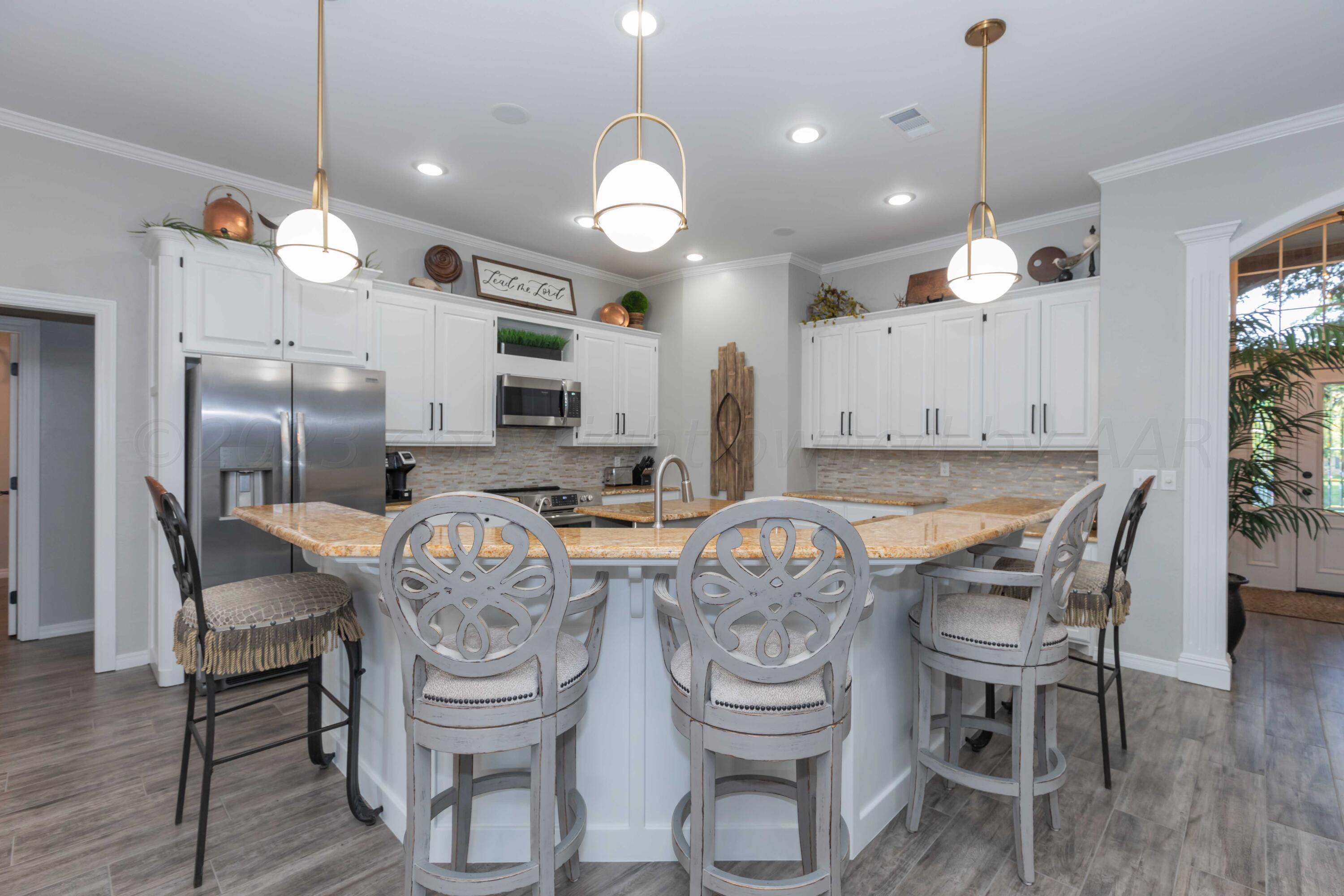 2308 Madera Place Amarillo, TX 79124 - Photo 14 of 61 a kitchen with a dining table and chairs