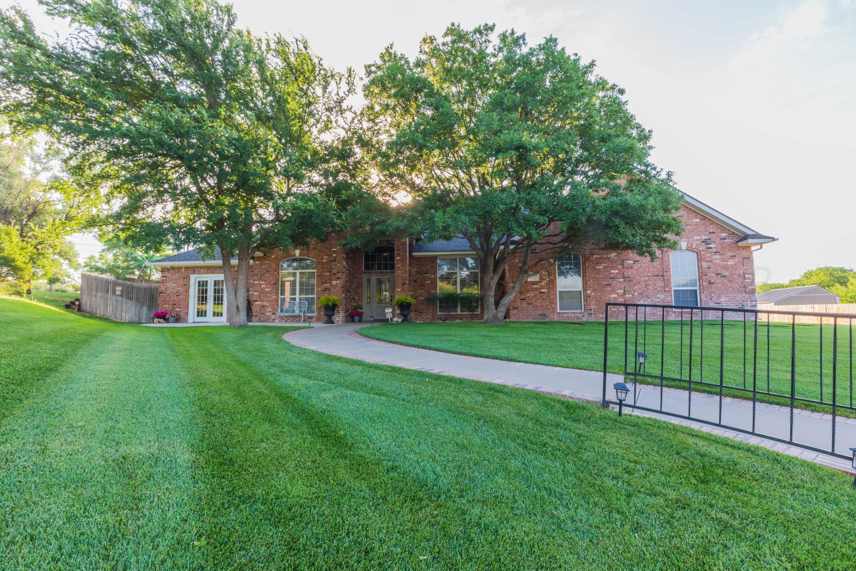 2308 Madera Place Amarillo, TX 79124 - Photo 2 of 61 a view of a house next to a big yard and large trees
