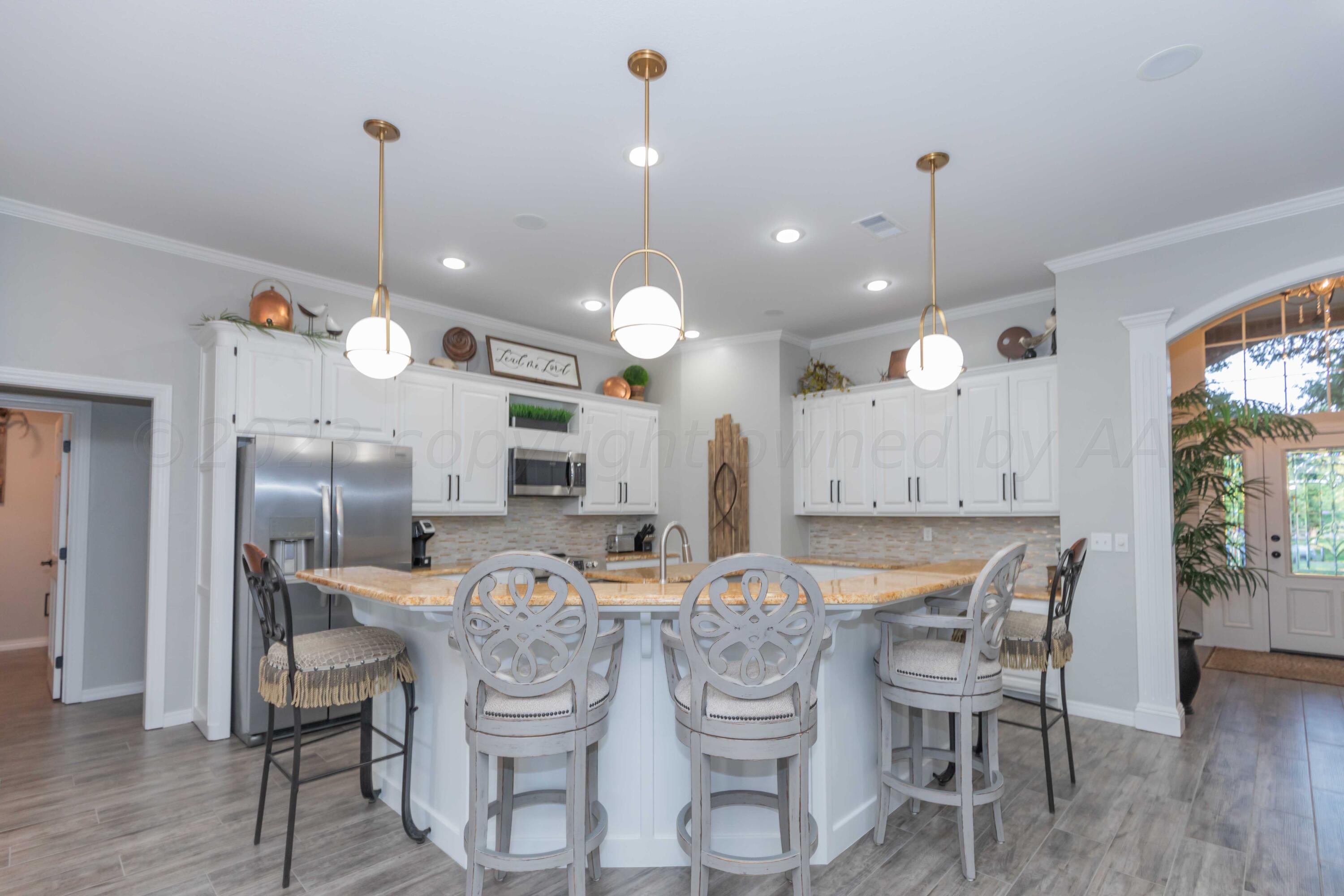 2308 Madera Place Amarillo, TX 79124 - Photo 21 of 61 a kitchen with a dining table chairs stainless steel appliances and cabinets