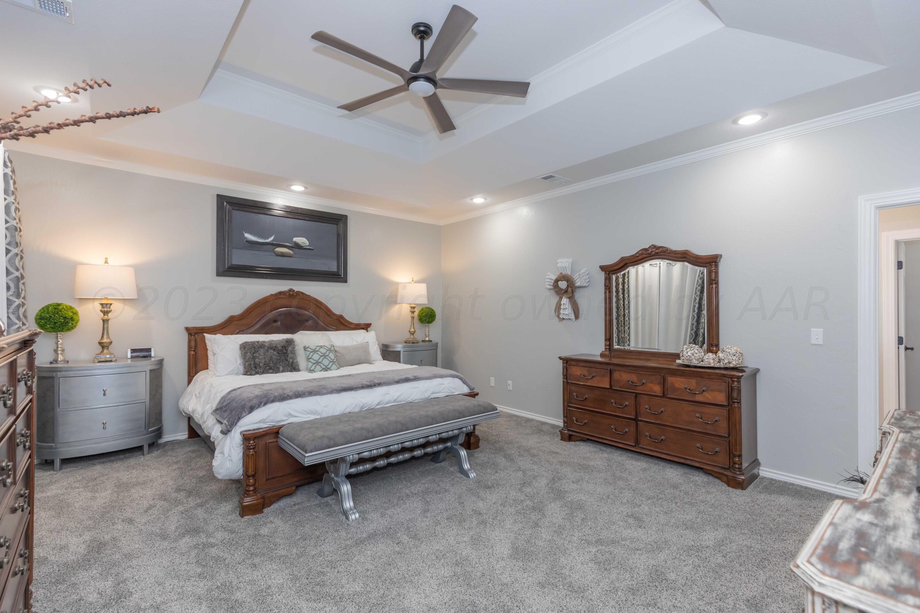 2308 Madera Place Amarillo, TX 79124 - Photo 29 of 61 a spacious bedroom with a bed and a chandelier