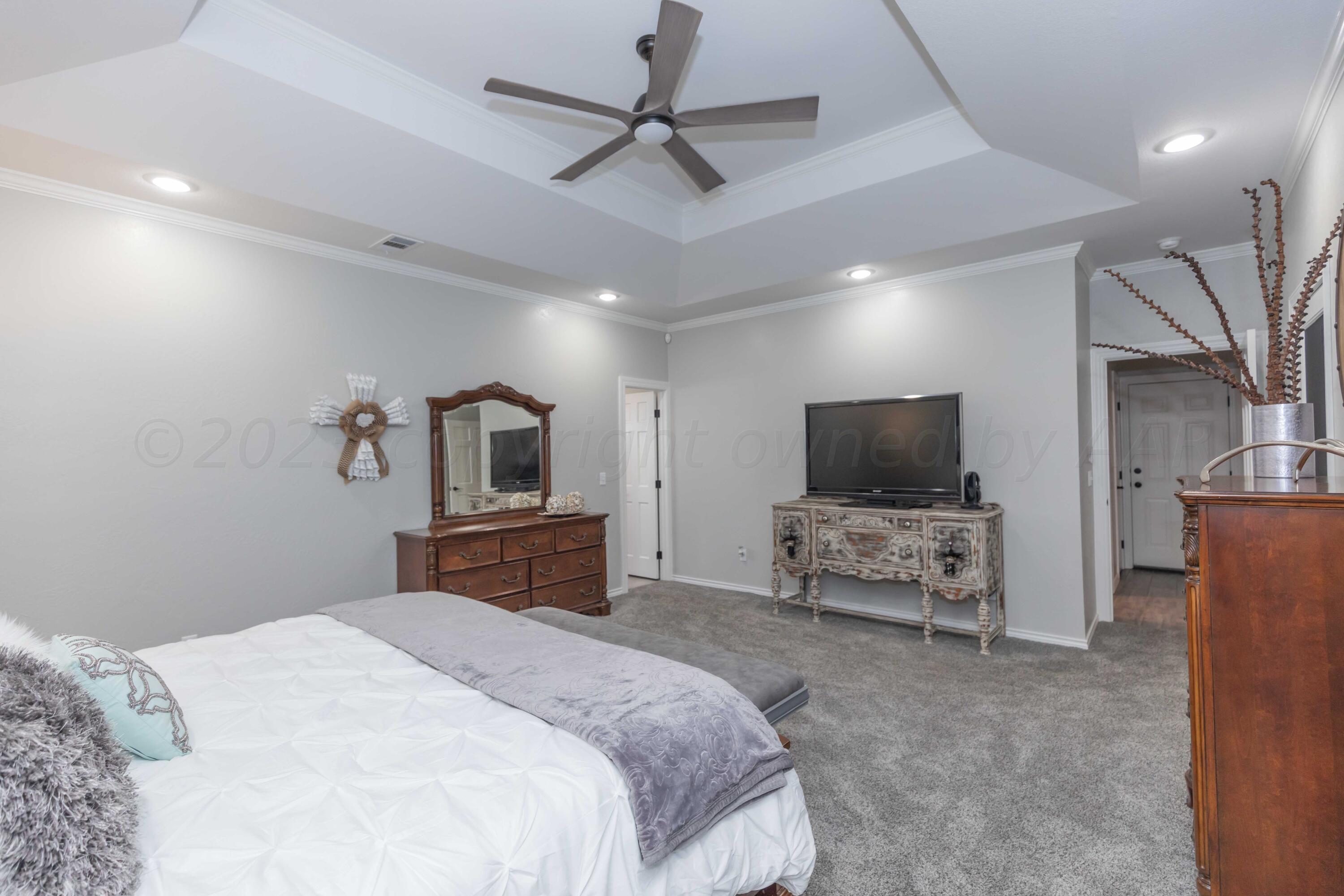 2308 Madera Place Amarillo, TX 79124 - Photo 30 of 61 a bedroom with a bed and a flat screen tv