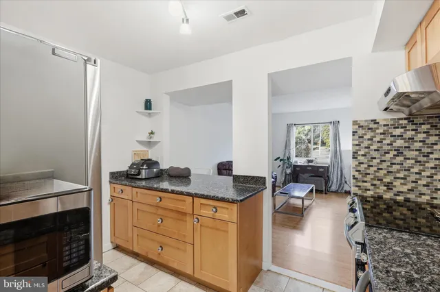 a kitchen with a refrigerator and a counter top space