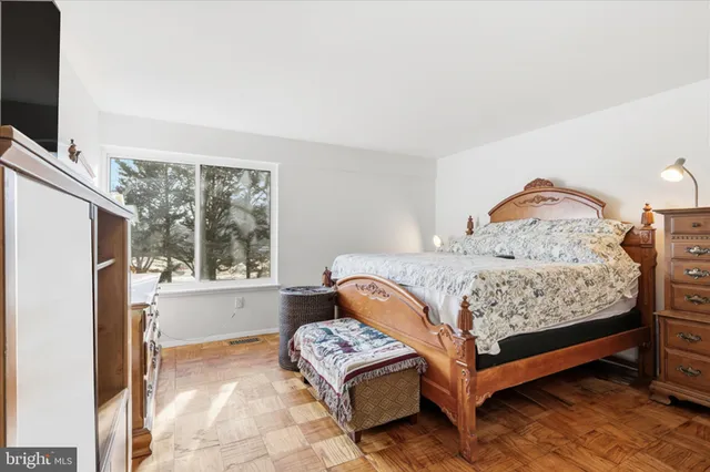 a bedroom with a bed and dresser