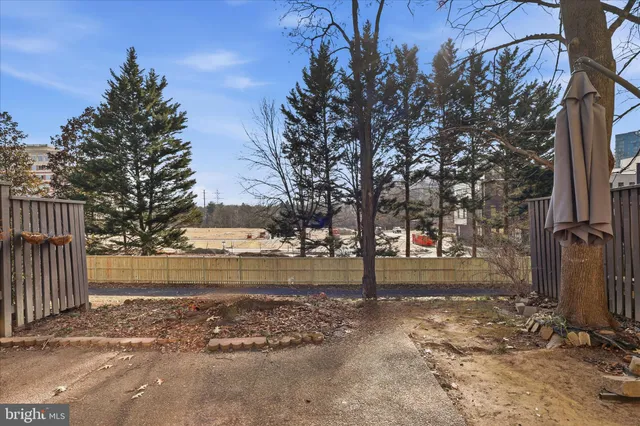 a backyard of a house with lots of green space and fountain