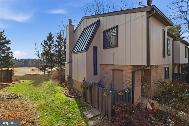 a view of a hallway to a livingroom and a potted plant