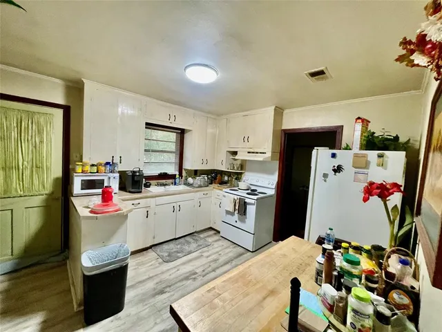 a kitchen with a refrigerator and microwave