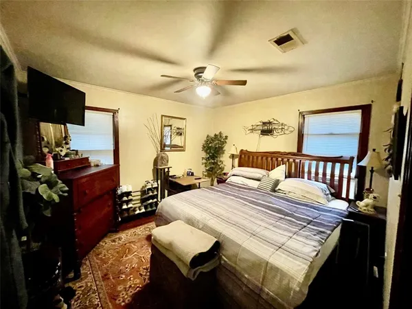 a bedroom with a bed dresser and a large mirror