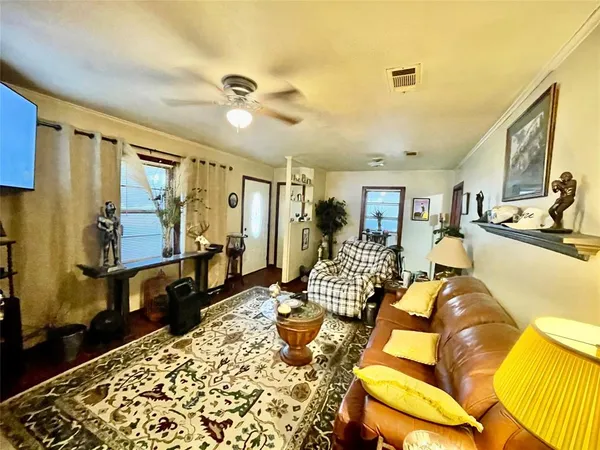 a living room with furniture rug and wooden floor