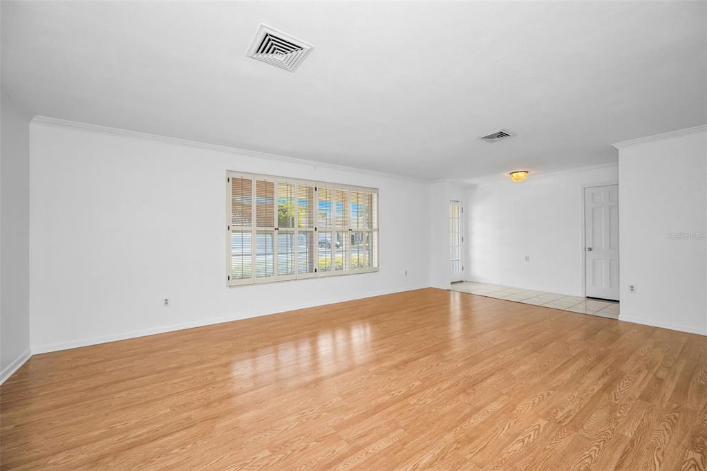 4 Hibiscus Road Belleair, FL 33756 - Photo 16 of 75 wooden floor in an empty room with a window