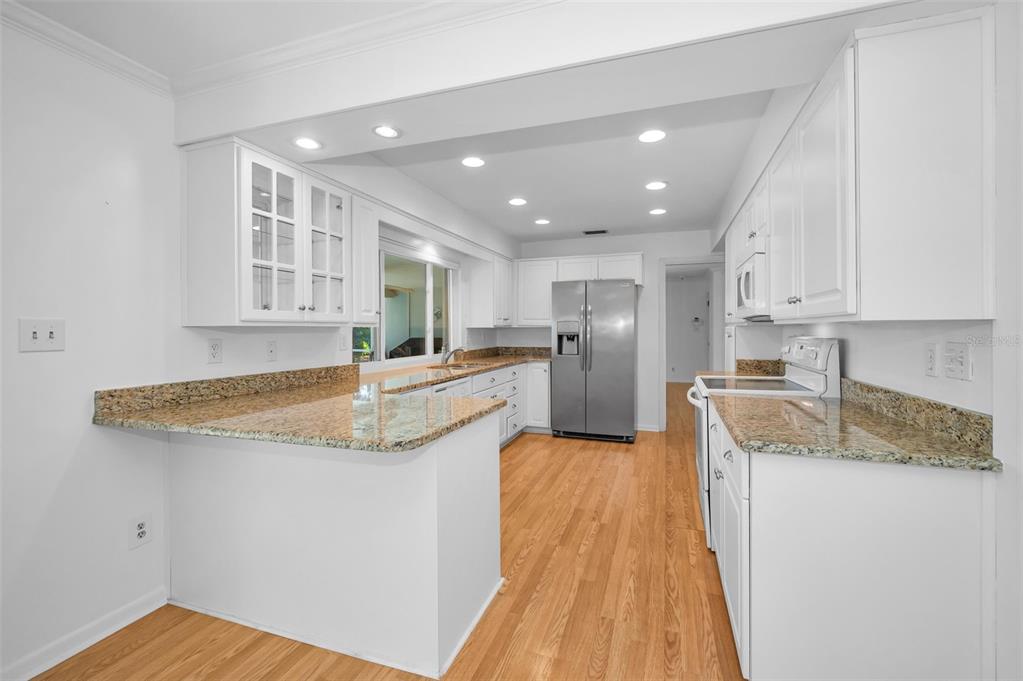 4 Hibiscus Road Belleair, FL 33756 - Photo 24 of 75 a kitchen with stainless steel appliances granite countertop a sink and a stove