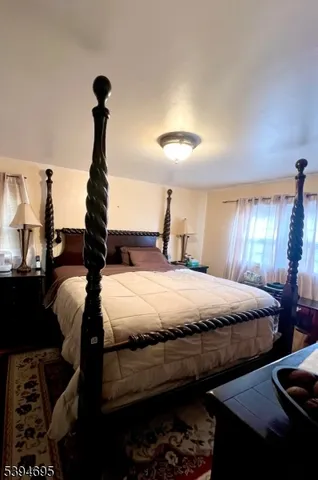 a bed sitting in a bedroom and chandelier