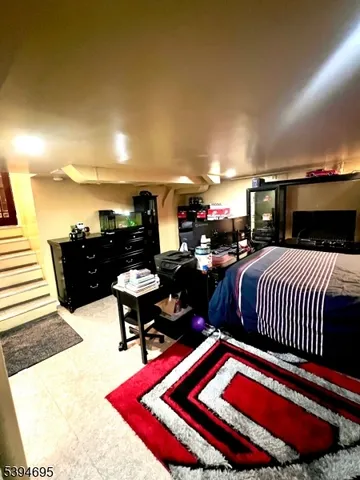 a living room with furniture a rug and potted plants