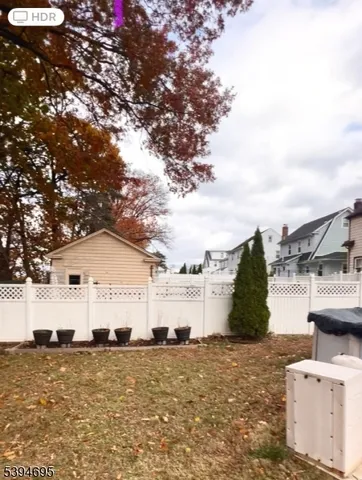 a view of a white house with a yard