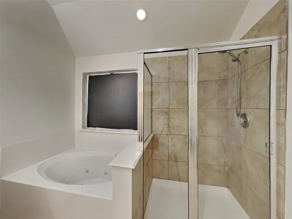 a bathroom with a bathtub and a shower