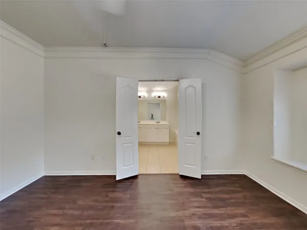 a view of an empty room and wooden floor and a window