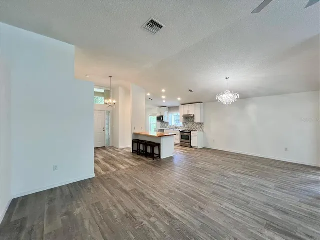 a view of kitchen with kitchen island and stainless steel appliances