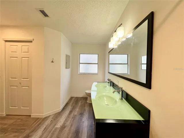 a bathroom with a sink a mirror and a window