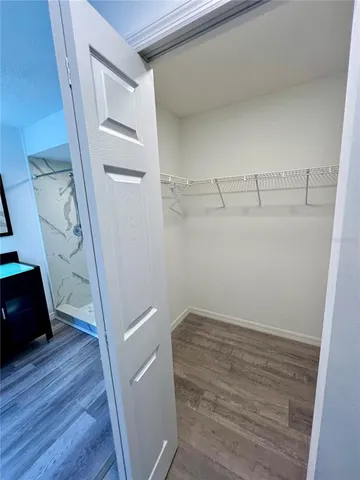 a view of storage and utility room with wooden floor
