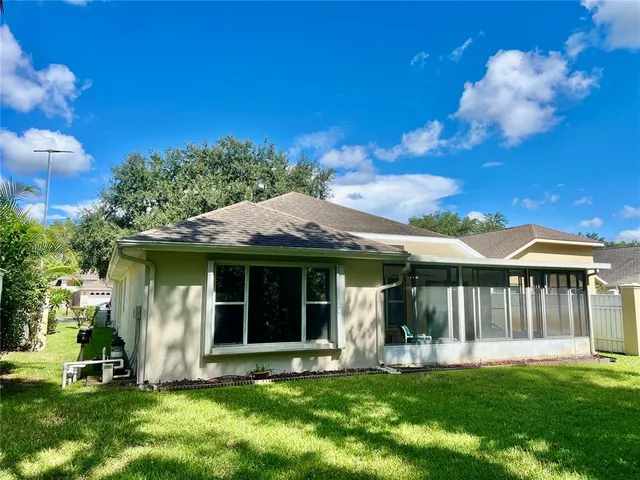 a view of a house with a yard and sitting area