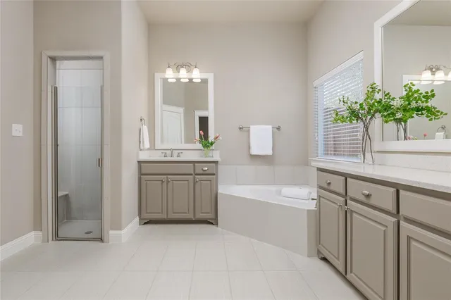 a spacious bedroom with a bed and a chandelier