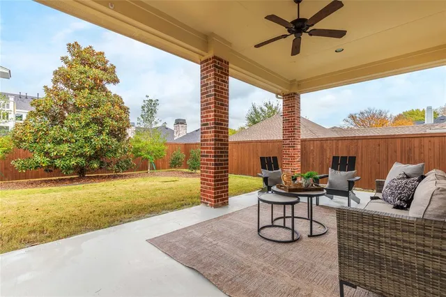 a view of a swimming pool with a table and chairs under an umbrella