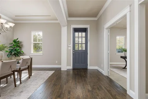 a view of a room with wooden floor and furniture