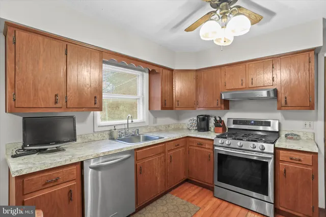 a kitchen with a sink stove and microwave
