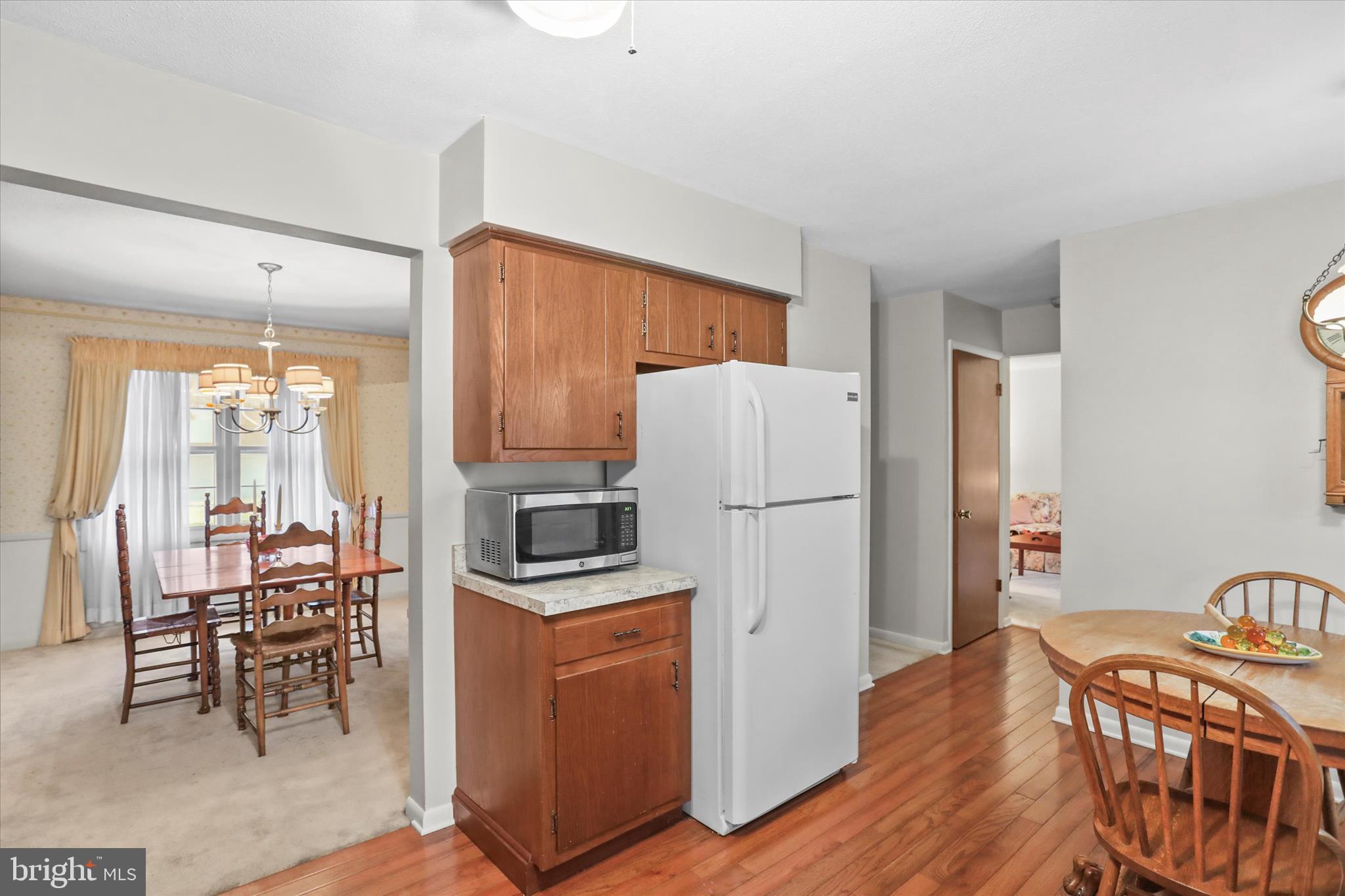 114 Lexington Road York, PA 17402 - Photo 17 of 49 a kitchen with stainless steel appliances a refrigerator a stove a dining table and chairs