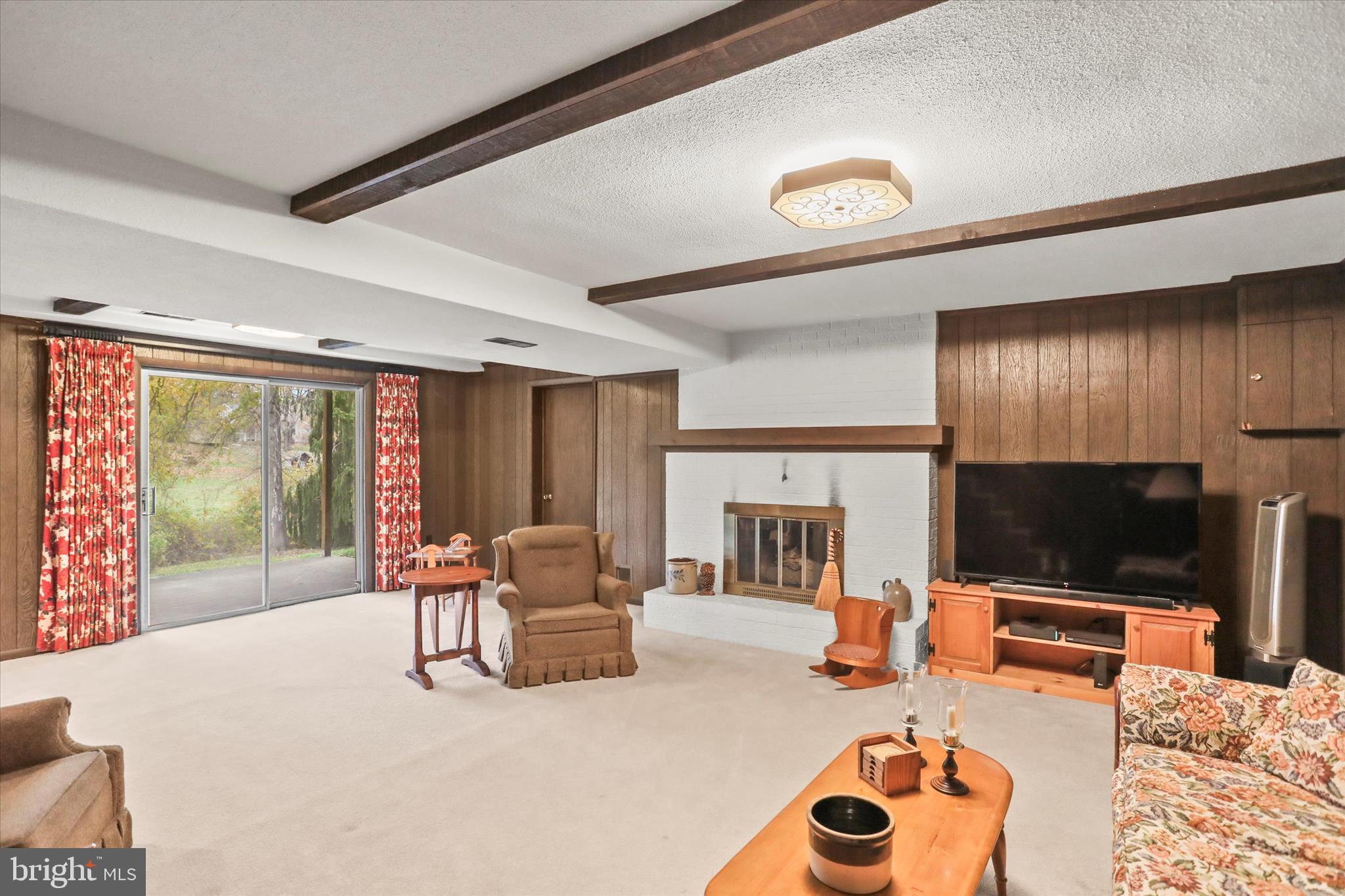114 Lexington Road York, PA 17402 - Photo 30 of 49 a living room with furniture a fireplace and a flat screen tv