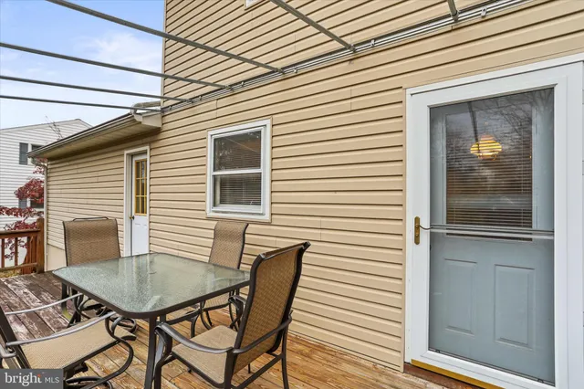 a balcony with table and chairs
