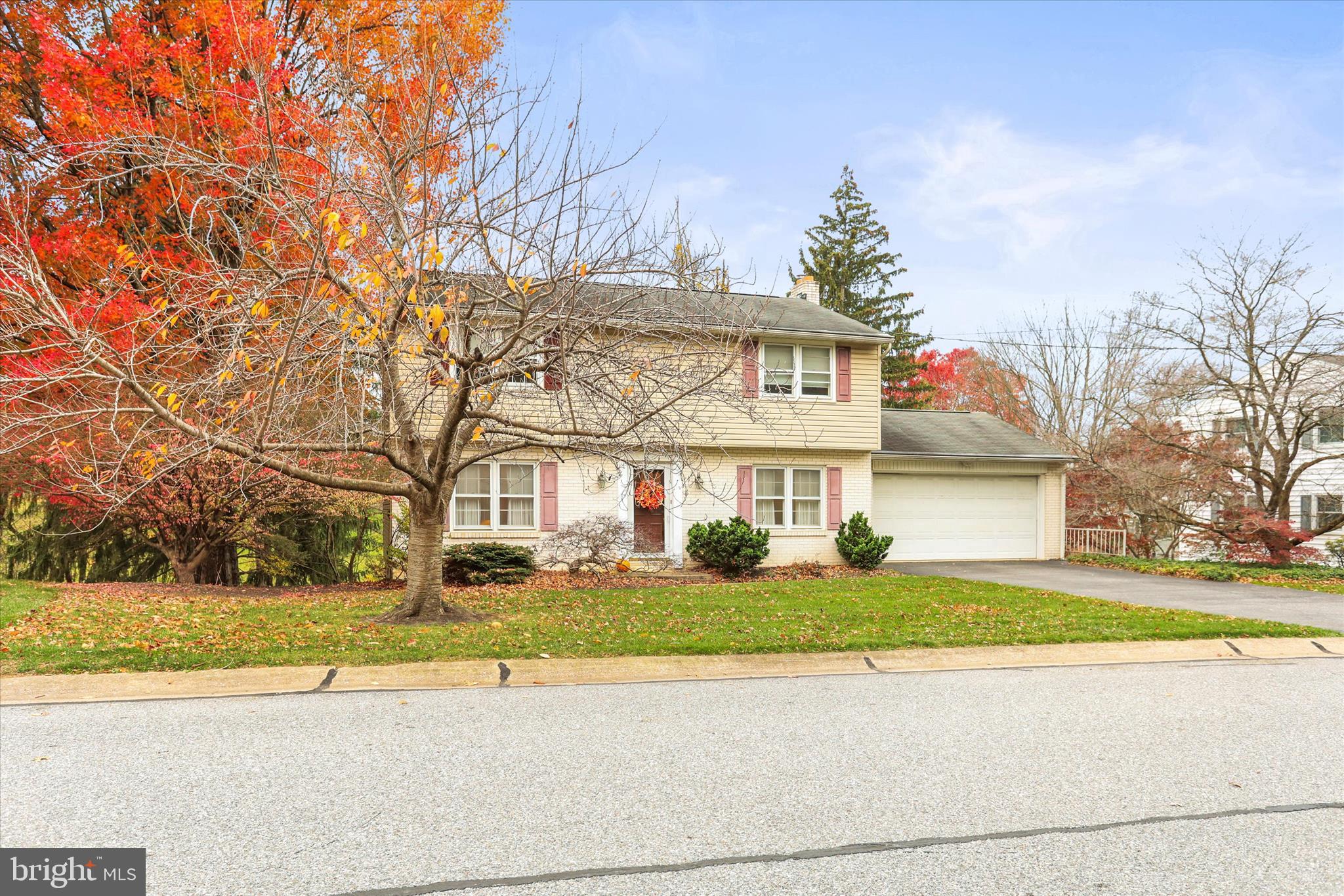 114 Lexington Road York, PA 17402 - Photo 4 of 49 a view of a white house next to a yard with large trees